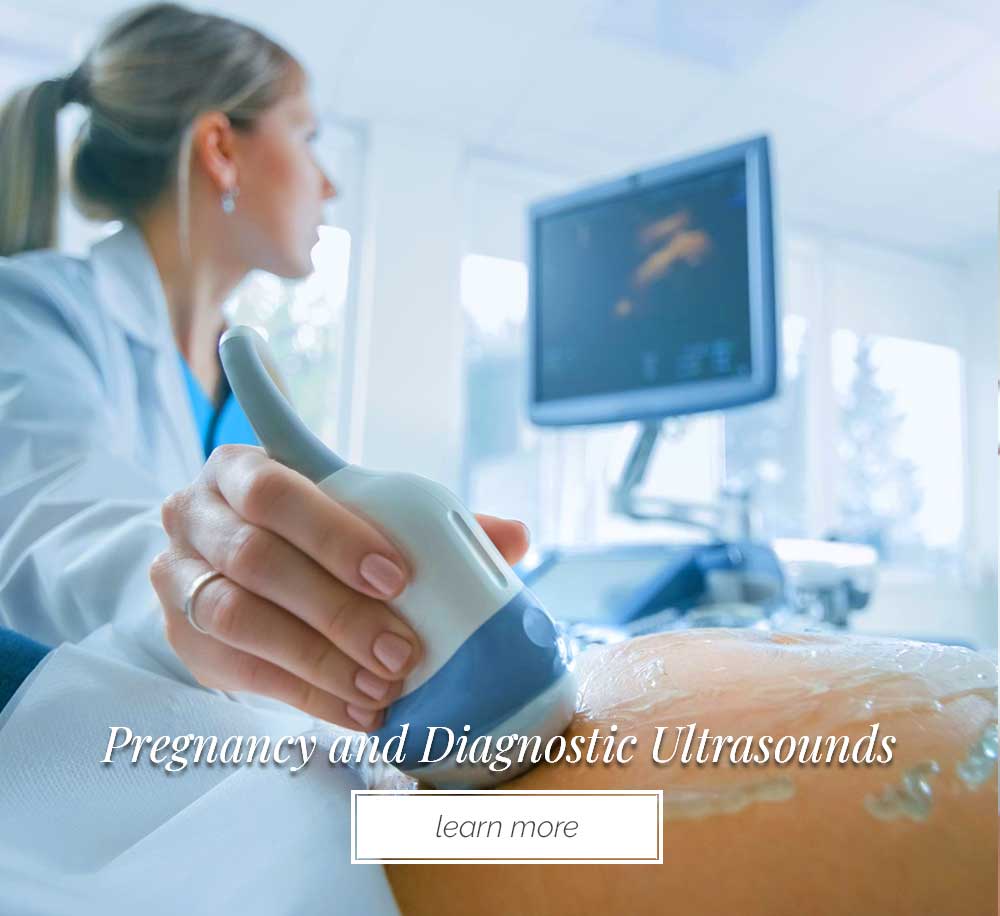 woman giving pregnancy ultrasound to another woman